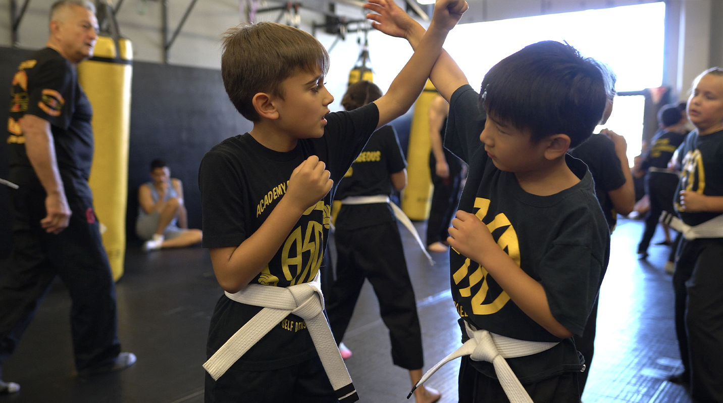 two boys sparring in martial arts class