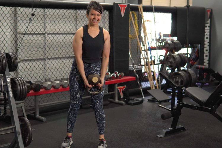 Woman working out at the gym smiling