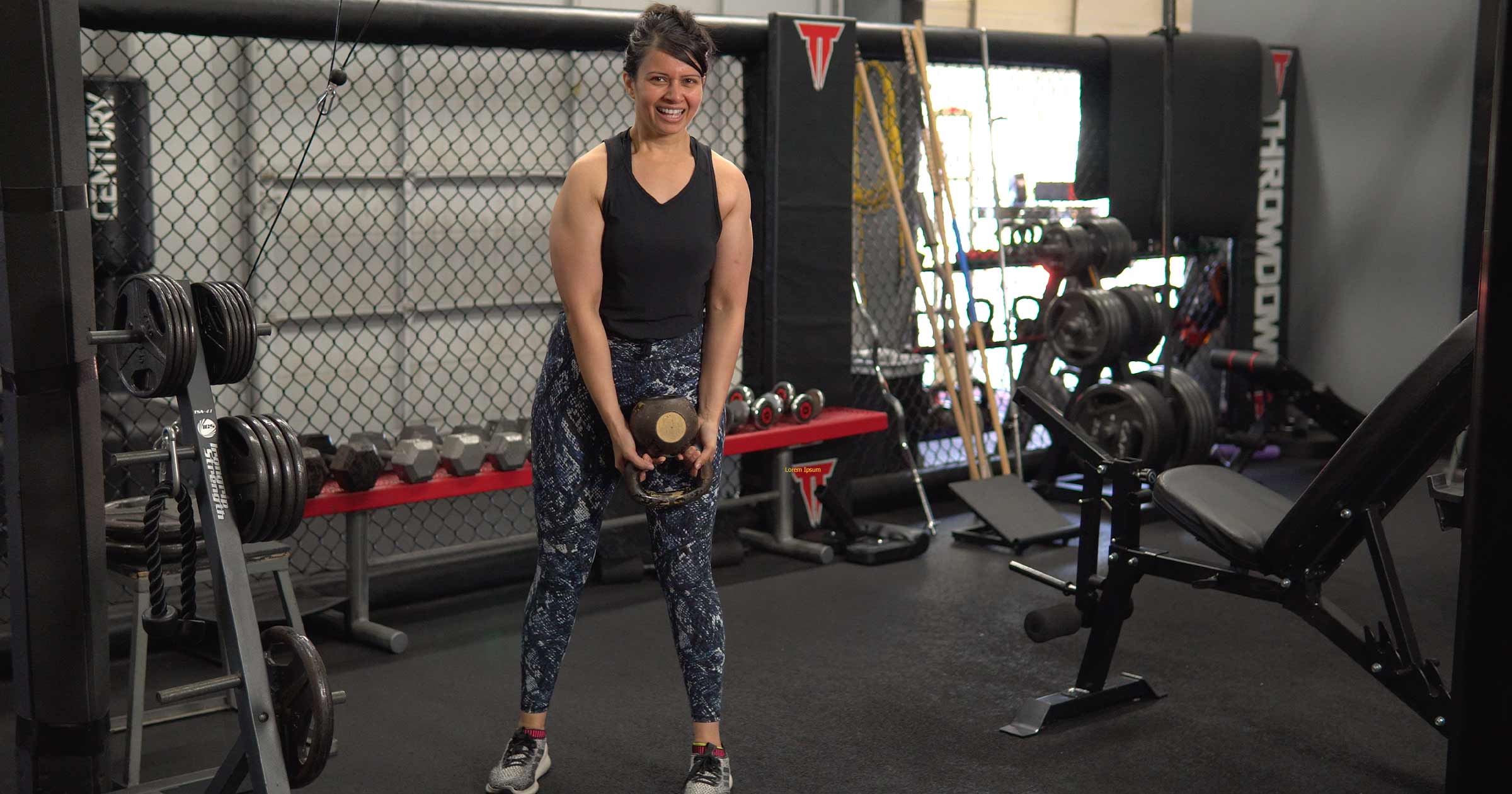 Woman working out at the gym smiling