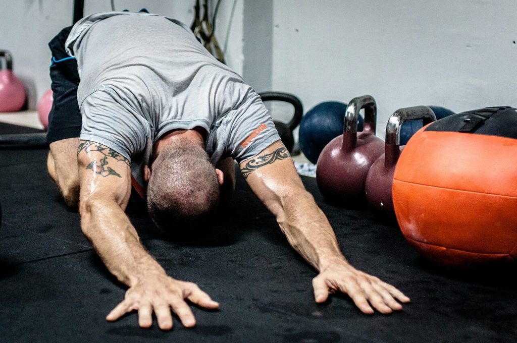 fit man stretching while working out