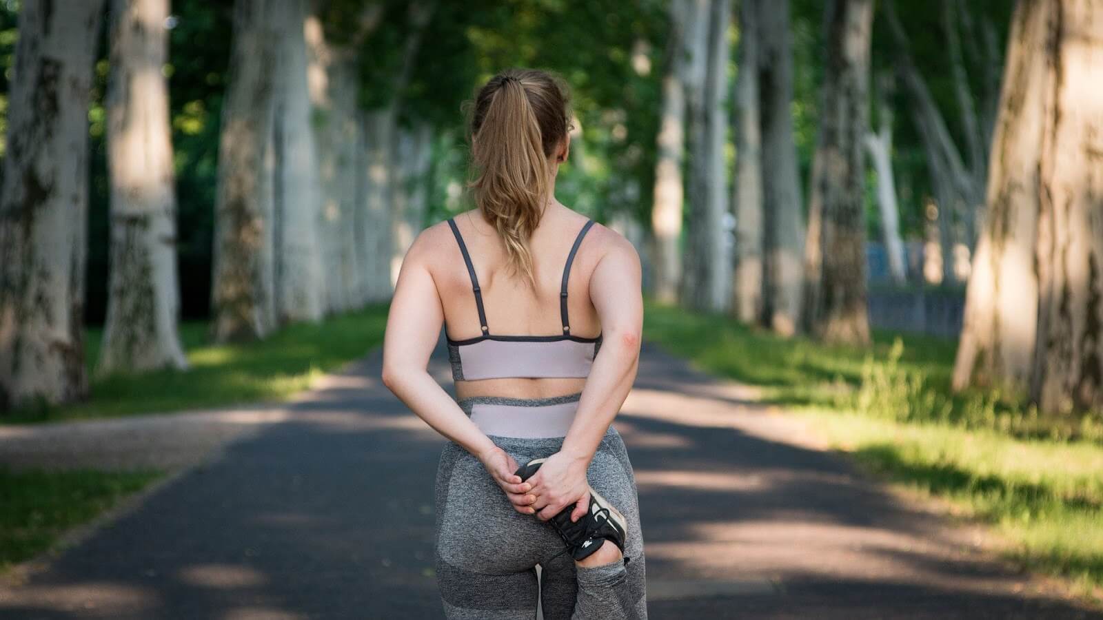 woman outdoors stretching before exercise