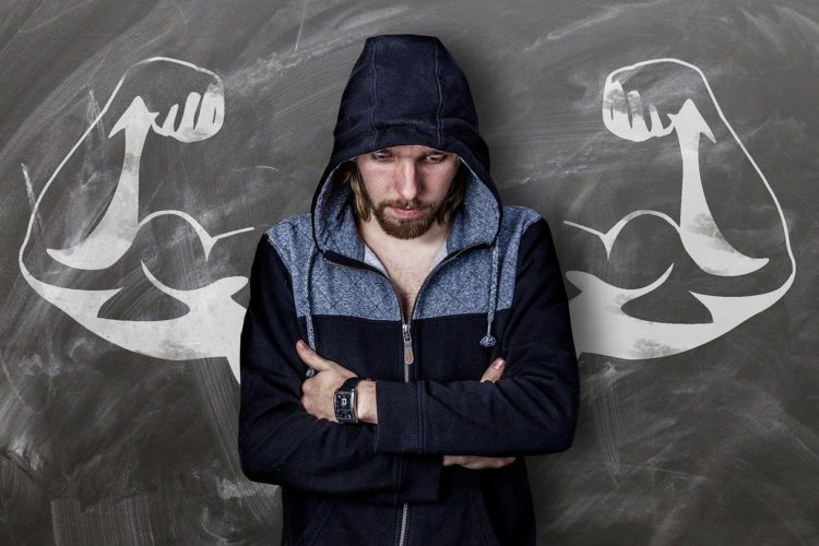 A man in a hoodie with muscley arms drawn behind him