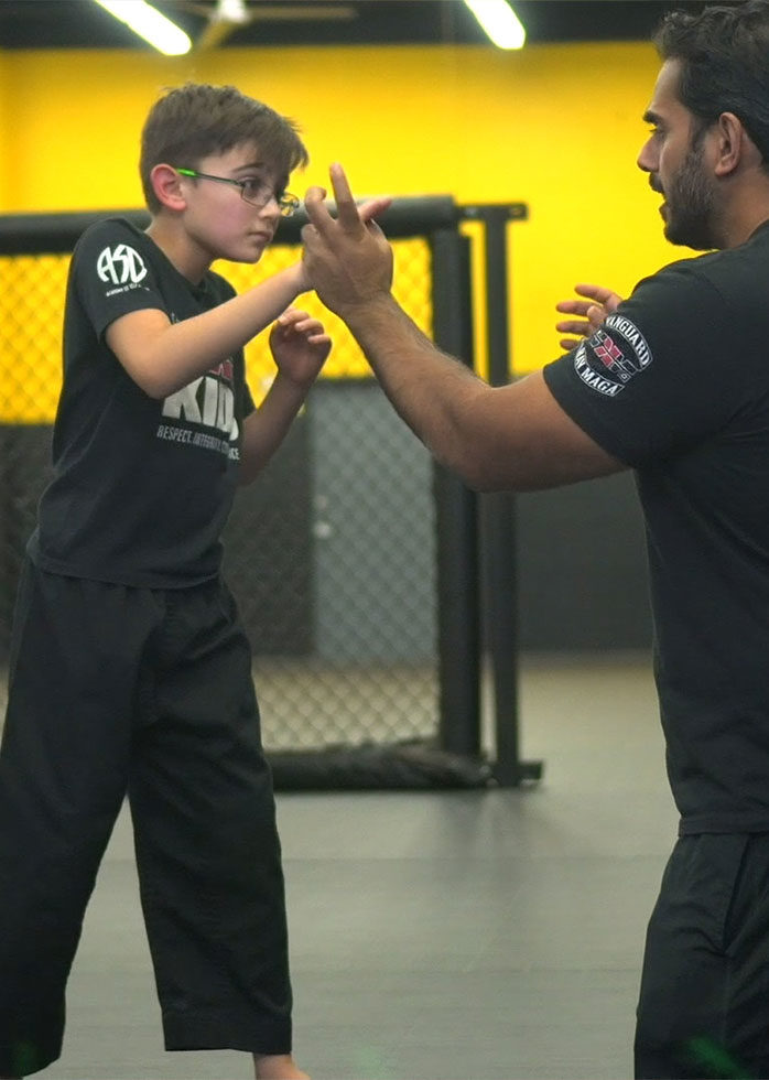 boy learning self defense moves