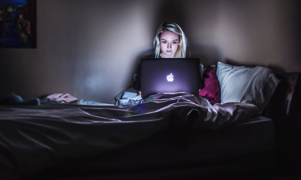 woman on her laptop in bed