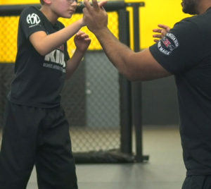 boy learning self defense moves
